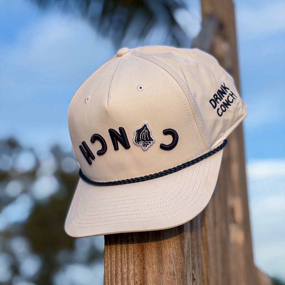 Drink Conch white Calypso hat sitting on wooden post