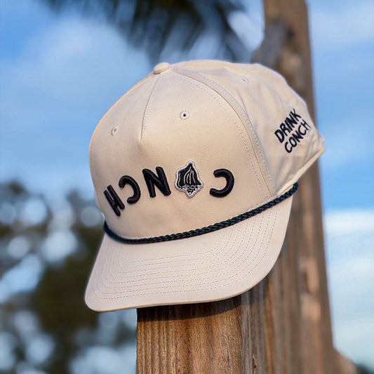 Drink Conch white Calypso hat sitting on wooden post